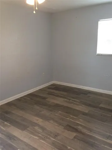 a view of a room with wooden floor