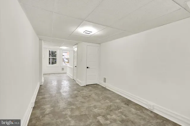 a view of room with window and wooden floor