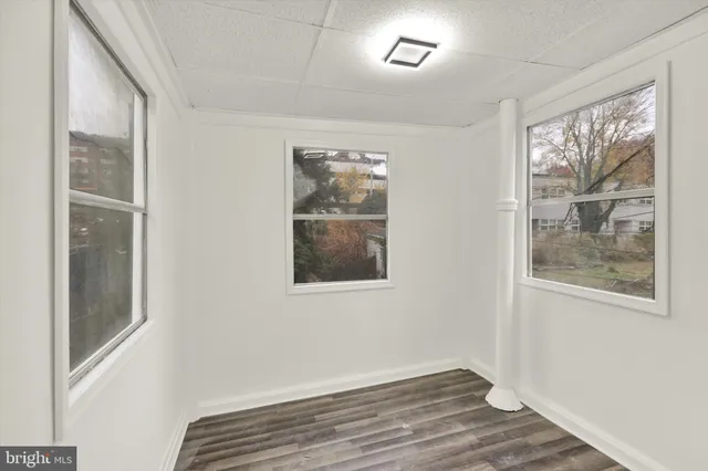 a room with two mirror and a washer