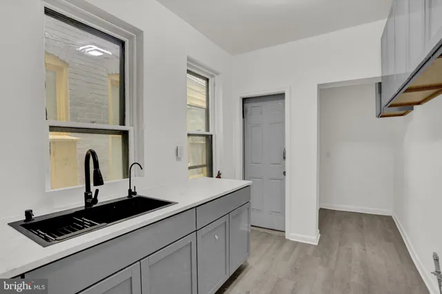a kitchen with a sink and a mirror