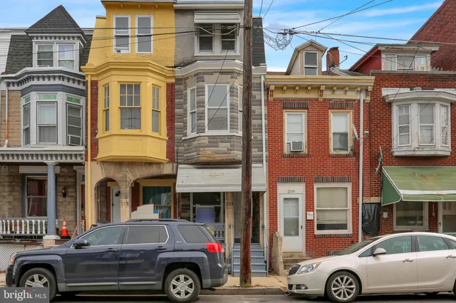 a front view of a house with parking space