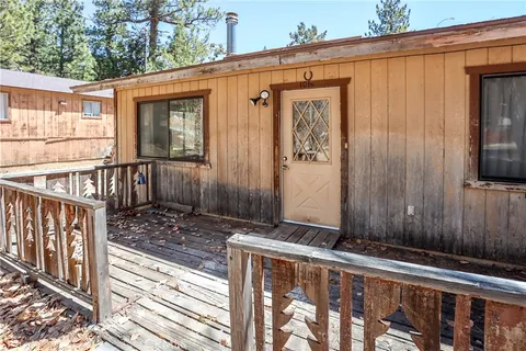 a view of a house with a wooden fence