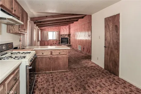 a kitchen with a stove a sink and a refrigerator