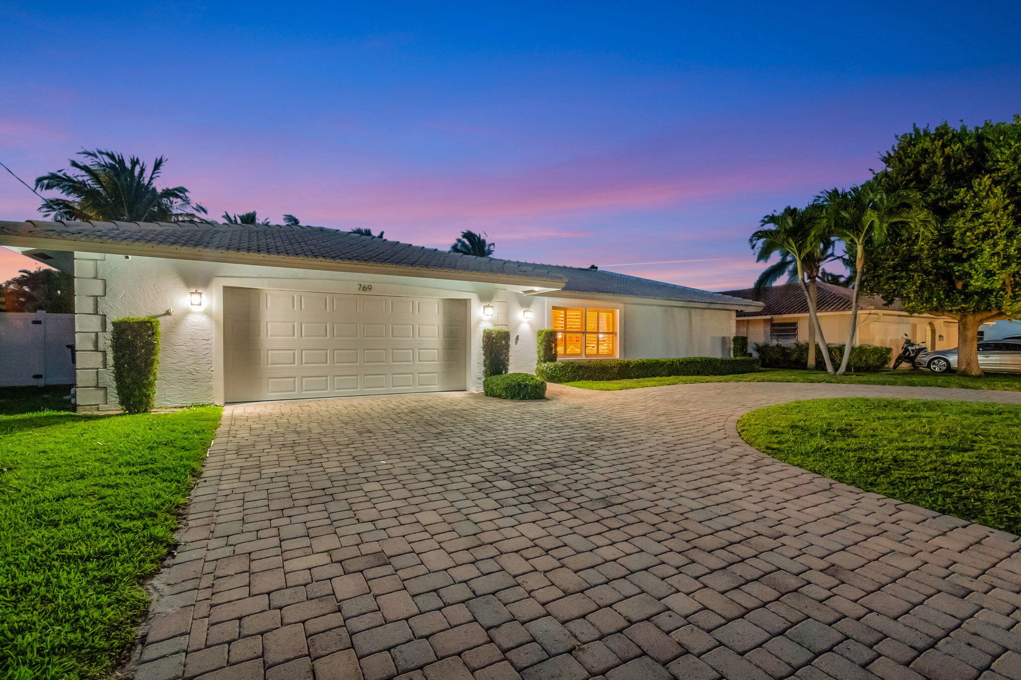 769 Berkley Street Boca Raton, FL 33487 - Photo 71 of 106 a front view of a house with a yard and garage