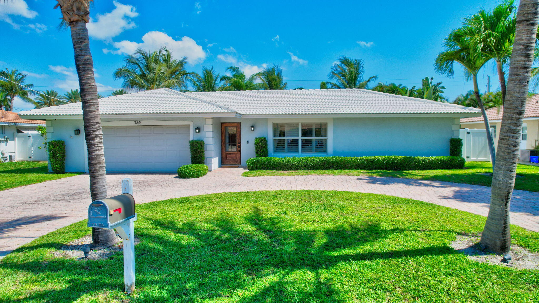 769 Berkley Street Boca Raton, FL 33487 - Photo 90 of 106 a front view of house with yard and green space