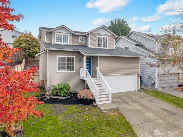 a front view of a house with a garden