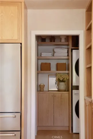a kitchen with a refrigerator and white cabinets