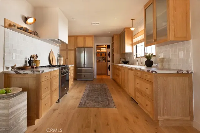 a living room with furniture a window and a potted plant