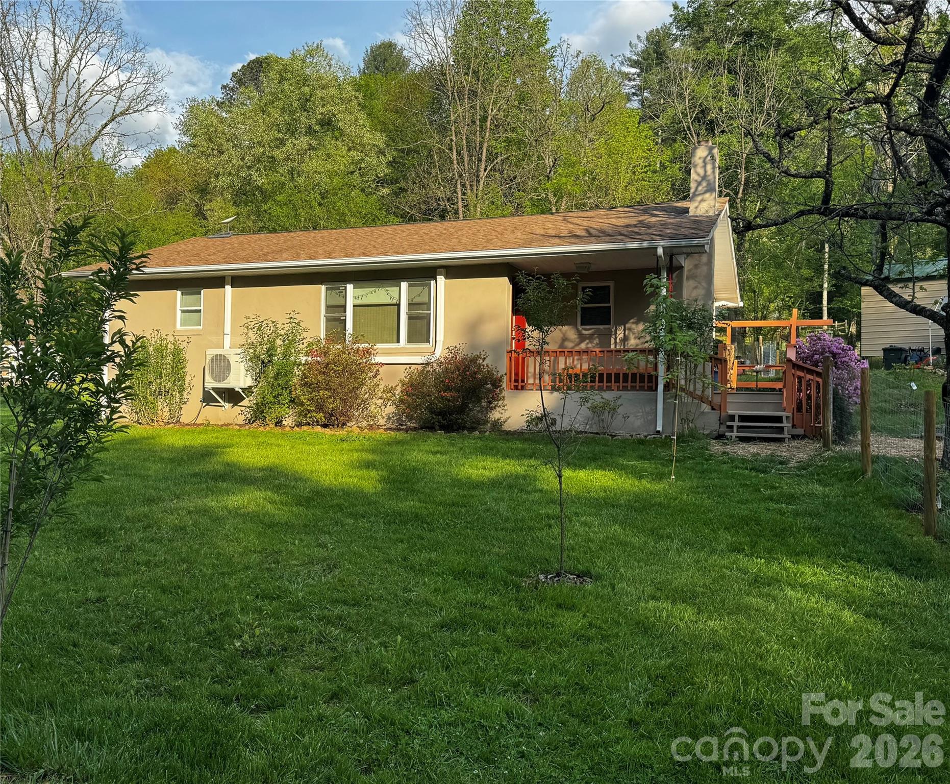 450 West Piney Mountain Road Whittier, NC 28789 - Photo 1 of 8 a view of a house with a yard and sitting area