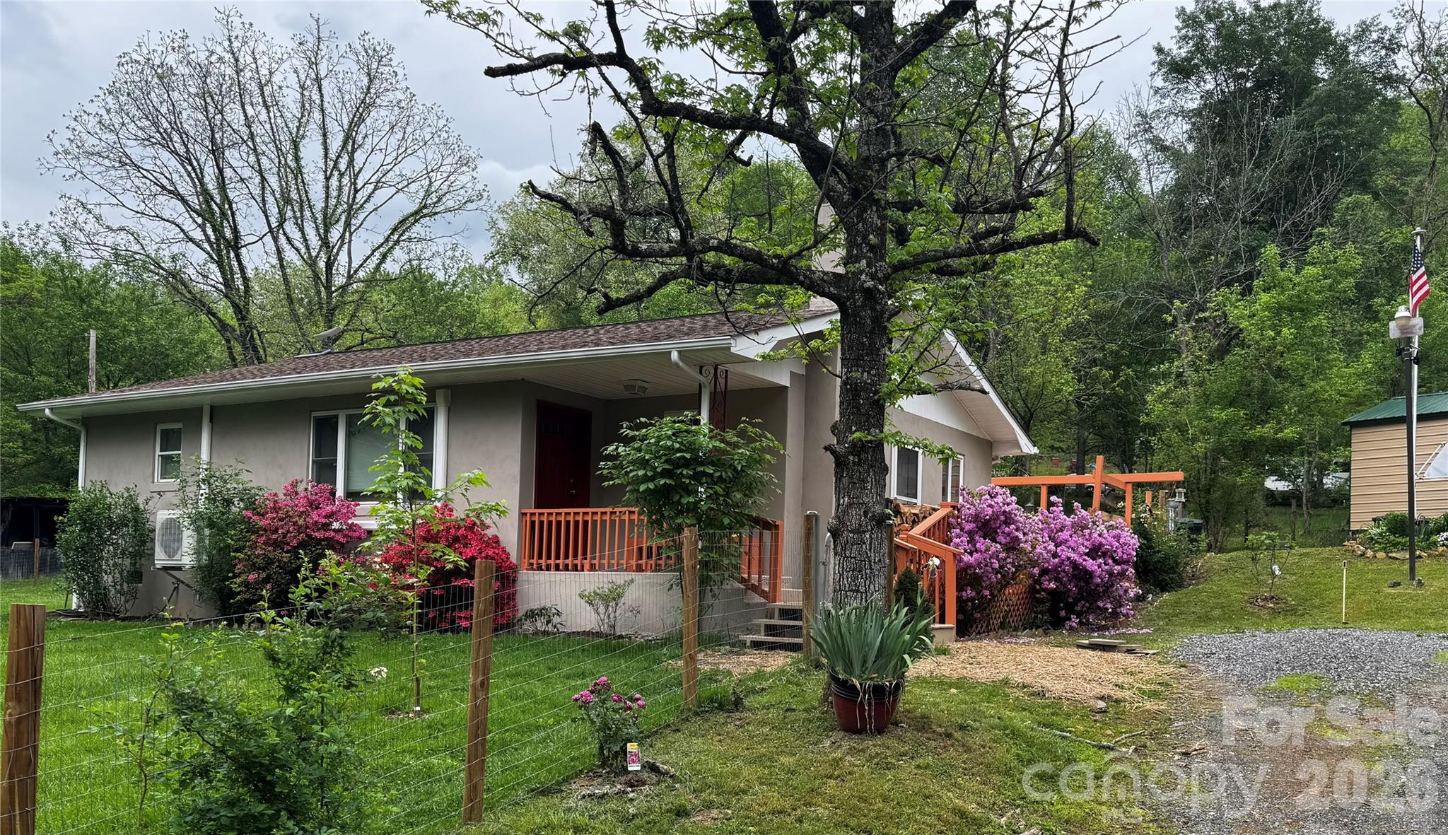 450 West Piney Mountain Road Whittier, NC 28789 - Photo 2 of 8 a front view of a house with garden