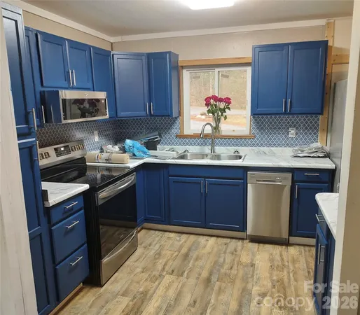 a kitchen with a sink a stove and cabinets