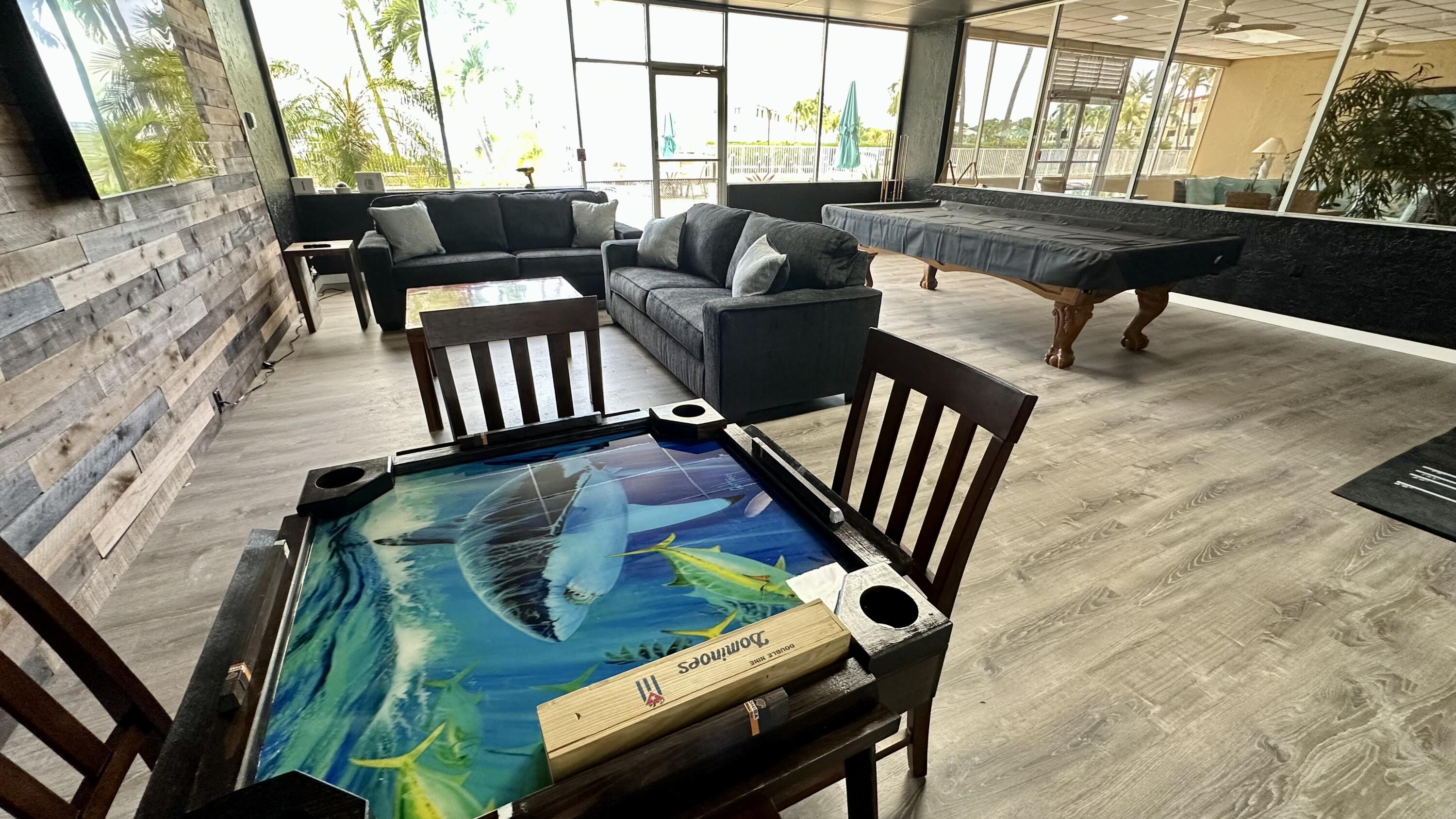 88500 Overseas Highway, Unit 413 Islamorada, FL 33036 - Photo 20 of 25 a living room with furniture fireplace and a flat screen tv