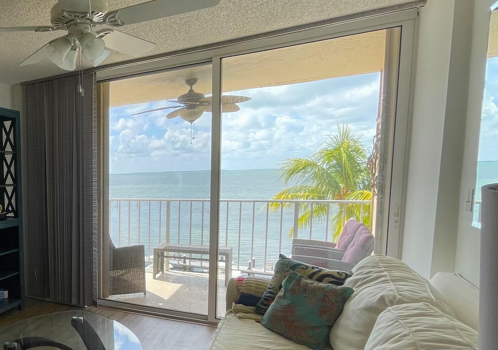 88500 Overseas Highway, Unit 413 Islamorada, FL 33036 - Photo 4 of 25 a view of a living room with a floor to ceiling window