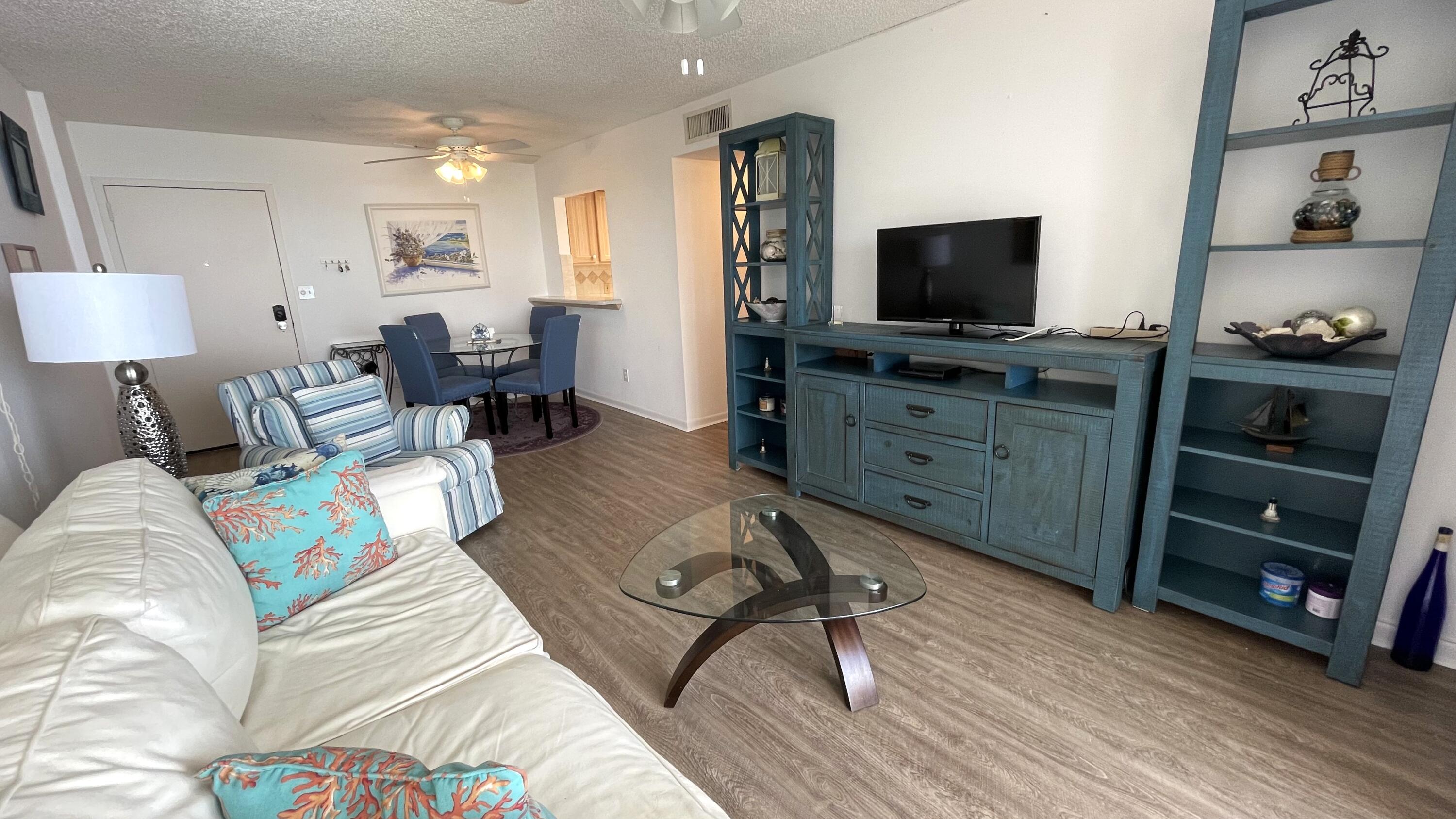 88500 Overseas Highway, Unit 413 Islamorada, FL 33036 - Photo 6 of 25 a living room with furniture and a flat screen tv