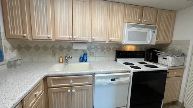 a kitchen with a sink cabinets and stainless steel appliances