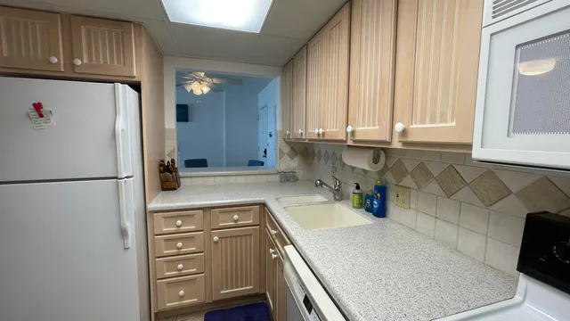 a kitchen with a refrigerator and a sink