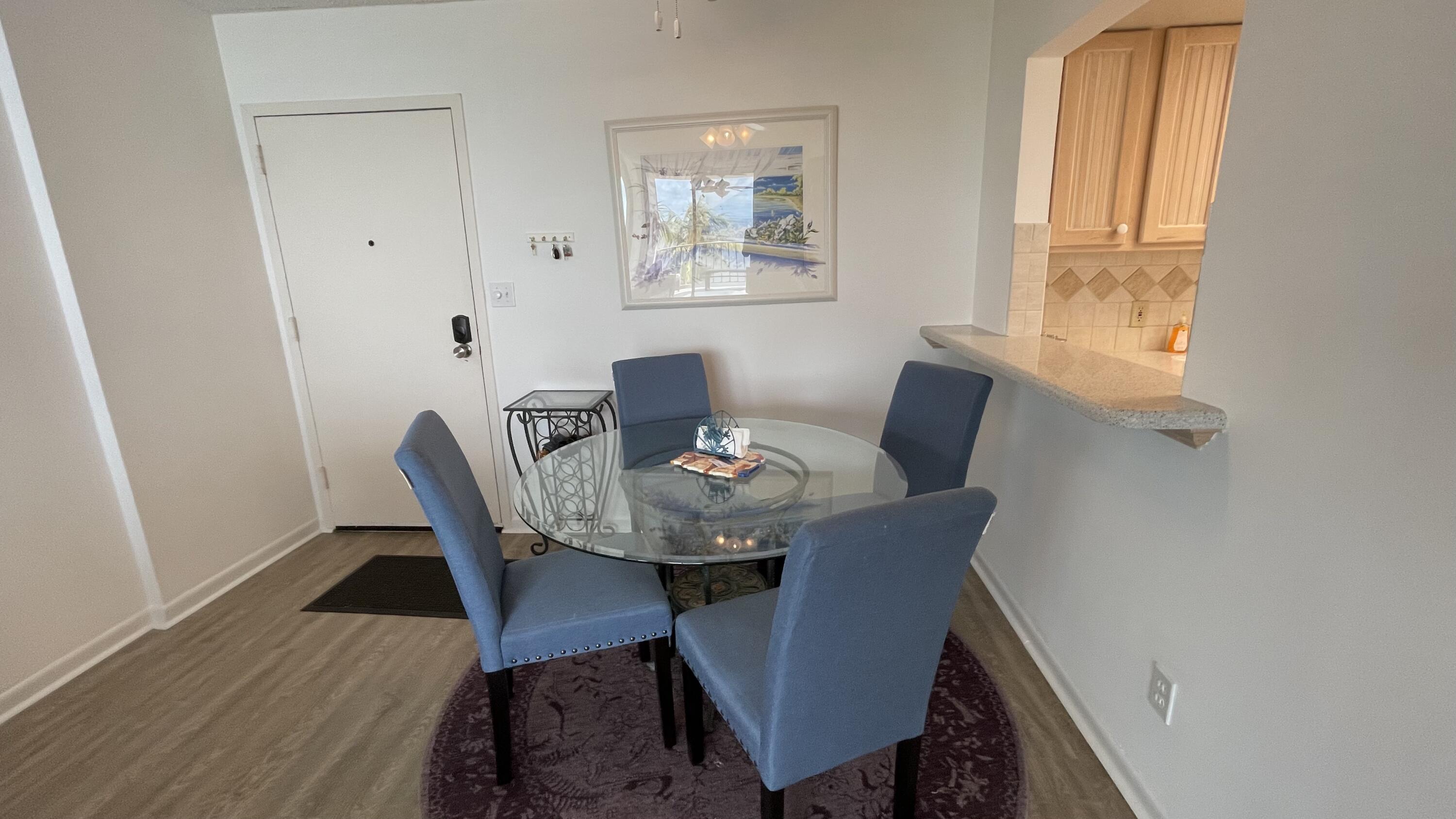 88500 Overseas Highway, Unit 413 Islamorada, FL 33036 - Photo 9 of 25 a view of a dining room with furniture window and wooden floor