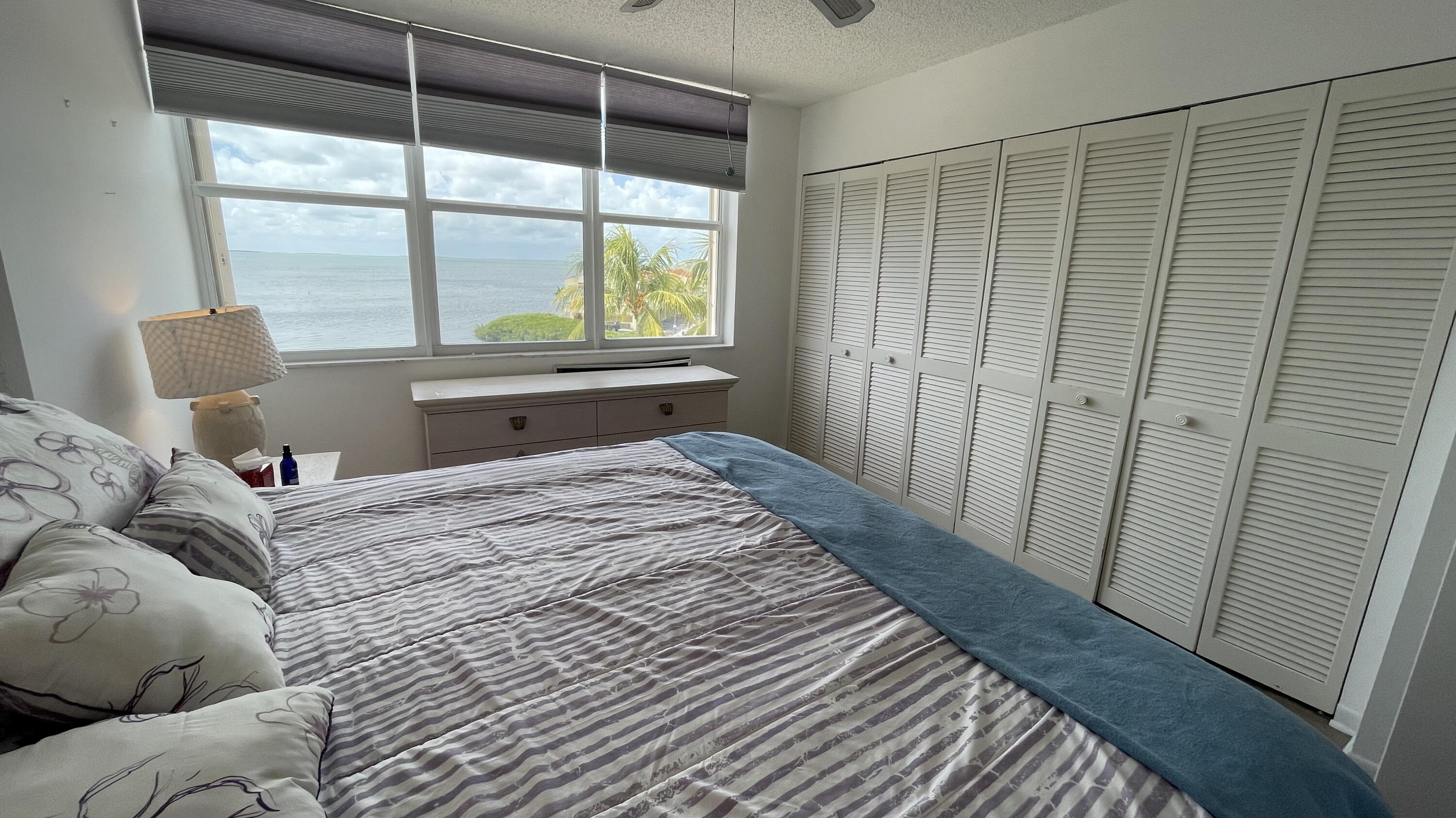88500 Overseas Highway, Unit 413 Islamorada, FL 33036 - Photo 10 of 25 a bedroom with a bed and a window