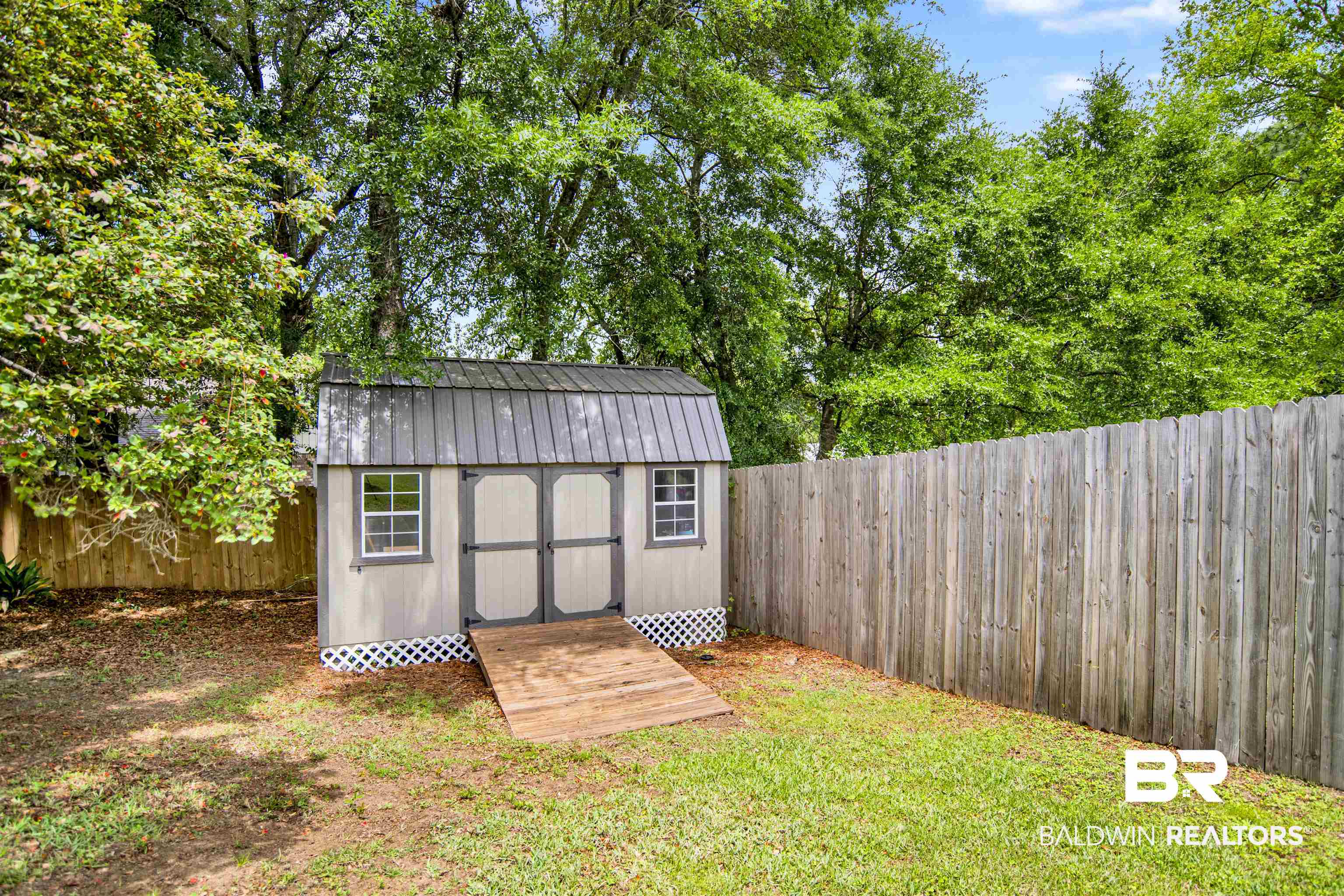 107 Virginia Circle Daphne, AL 36526 - Photo 35 of 47 Detached storage shed featuring a metal roof, double doors, two windows, and a wood ramp