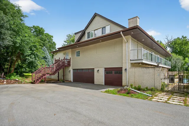 front view of house with a yard and car parked