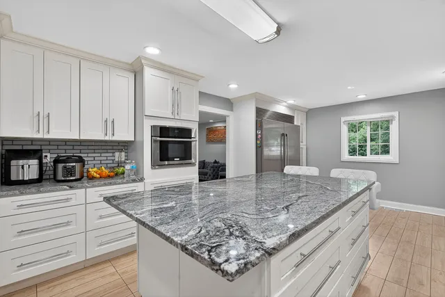 a kitchen with stainless steel appliances granite countertop a stove and a sink