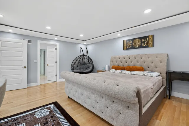 a bedroom with a bed and a large mirror