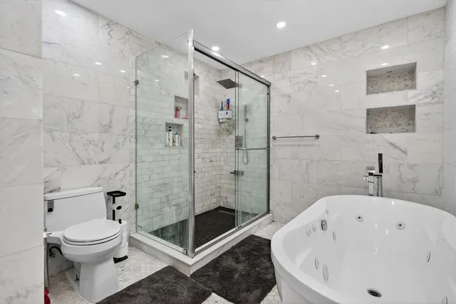 a living room with a bed furniture and a large window