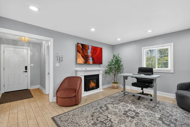 a living room with furniture a fireplace and a flat screen tv