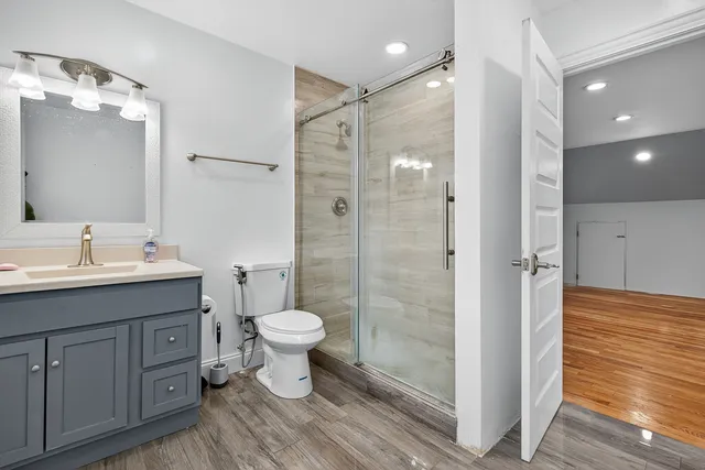 a bedroom with a large bed and a potted plant