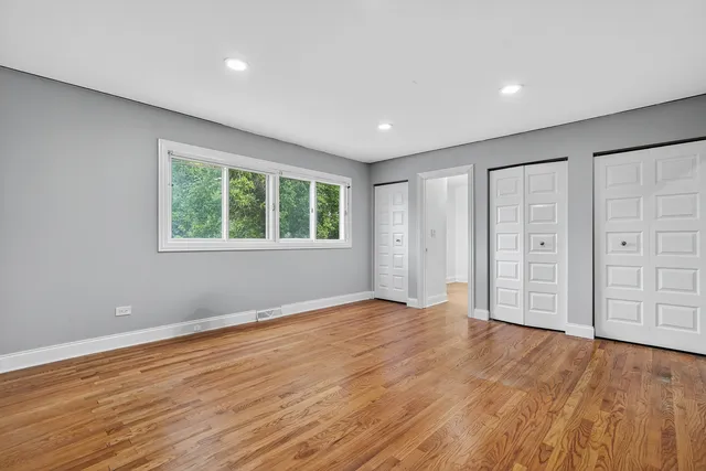 a view of a room with wooden floor and white walls