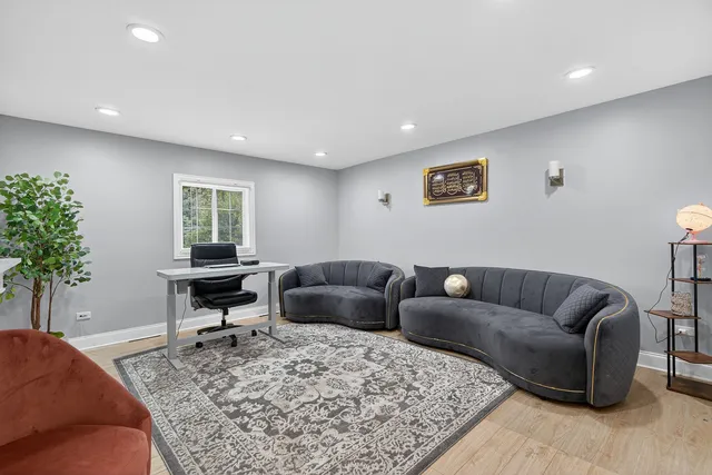 a living room with furniture and a potted plant