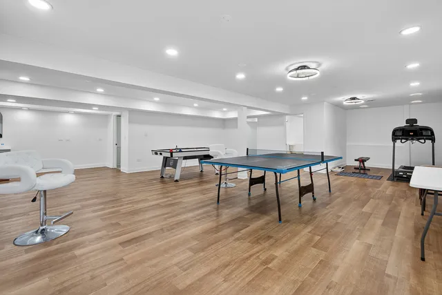 a view of a room with furniture and wooden floor