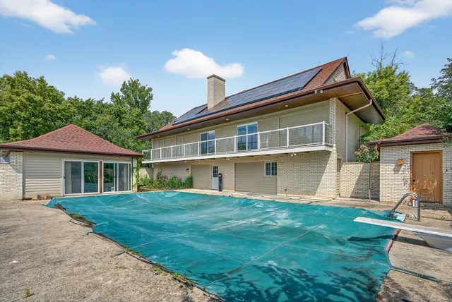 an aerial view of a house with garden space and street view