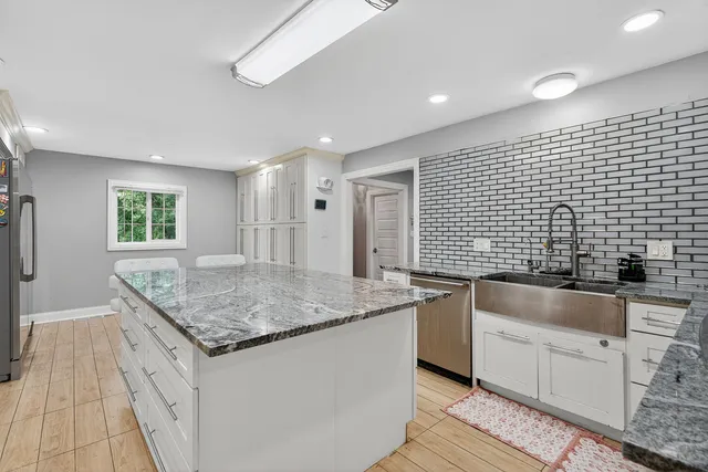 a kitchen with stainless steel appliances granite countertop a sink and a granite counter tops