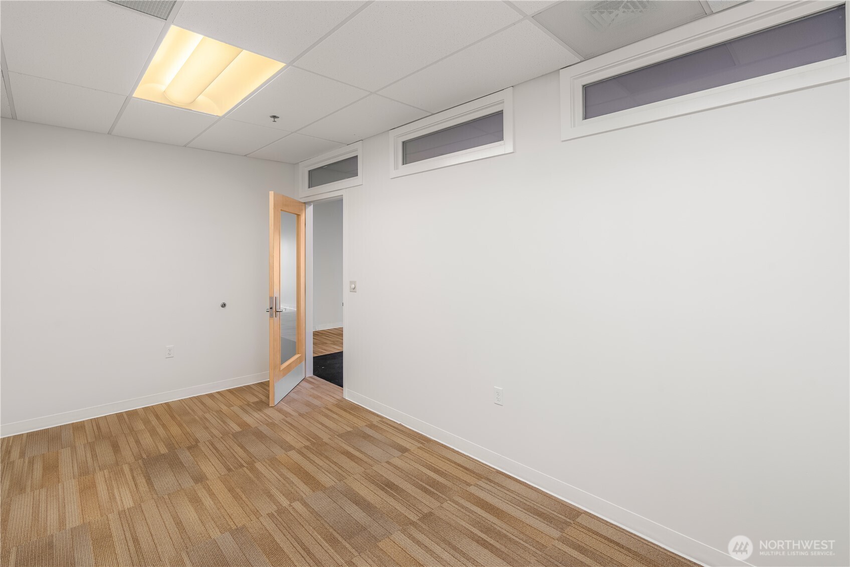 1207 North 152nd Street, Unit B Shoreline, WA 98133 - Photo 3 of 11 a view of empty room with wooden floor and fan