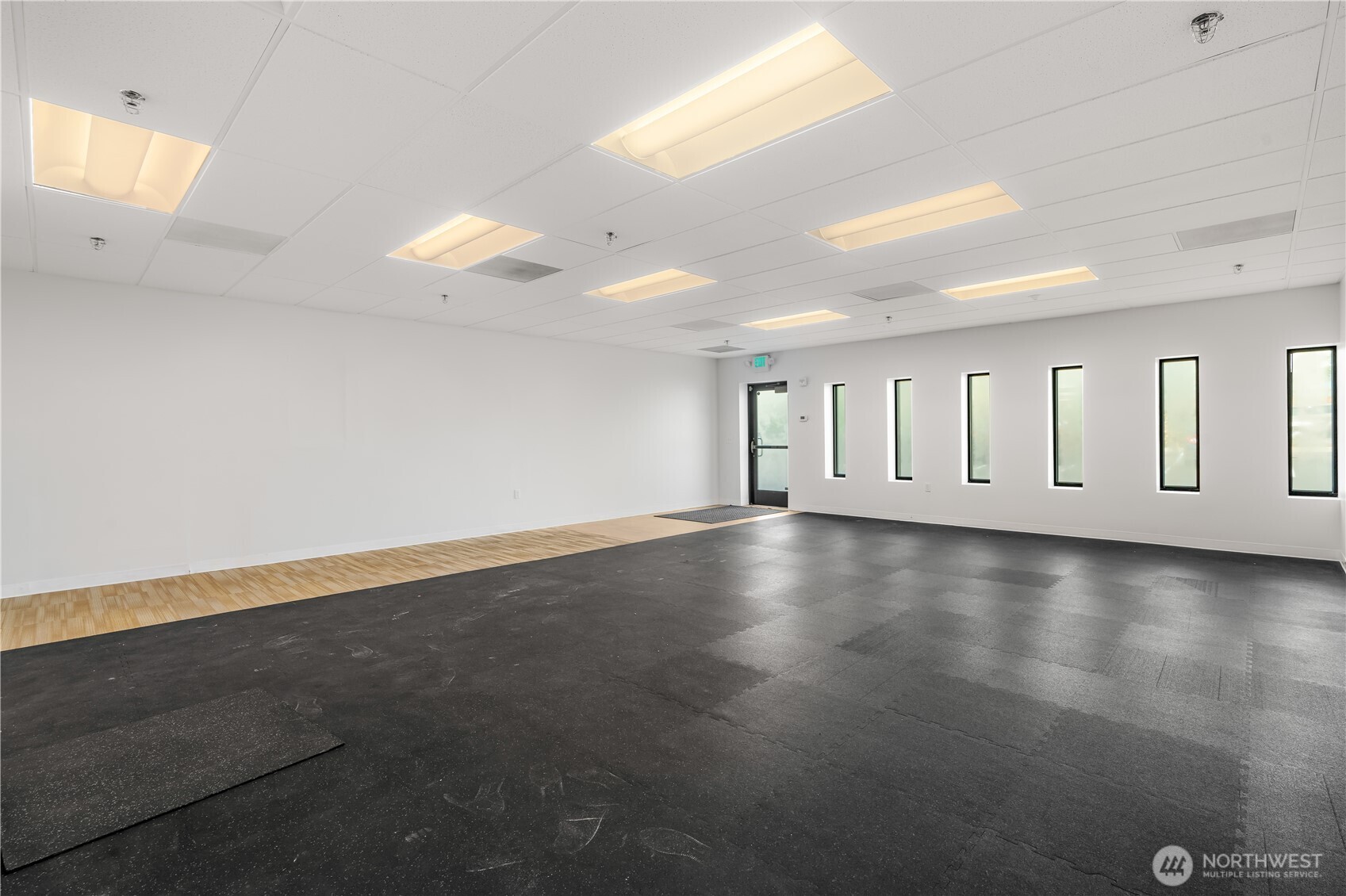 1207 North 152nd Street, Unit B Shoreline, WA 98133 - Photo 6 of 11 an empty room with wooden floor and windows