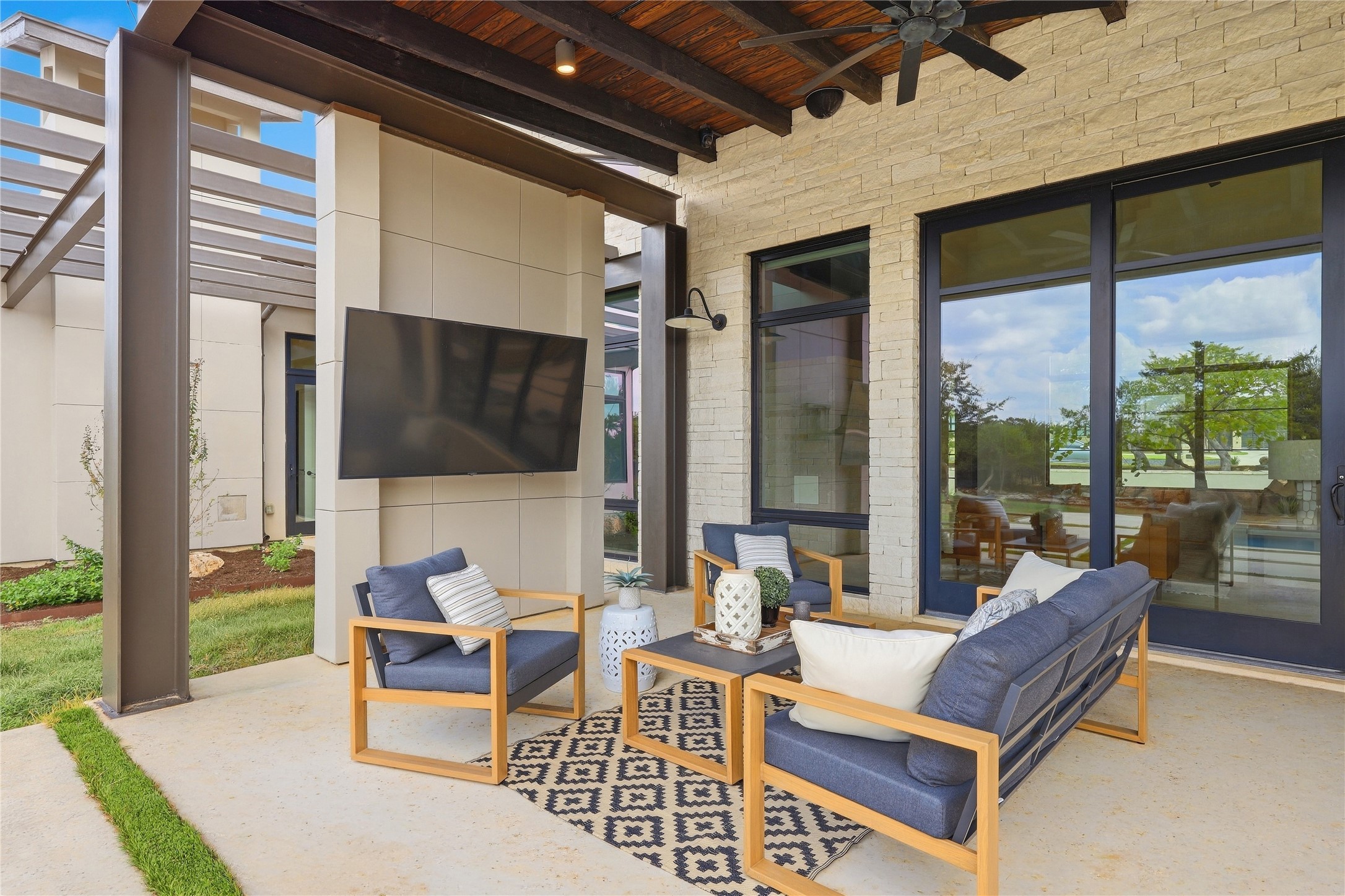 449 Ranch Falls Fair Oaks Ranch, TX 78015 - Photo 26 of 39 An inviting covered patio showcases handsome wood-paneled ceilings alongside textured stone and smooth composite walls.