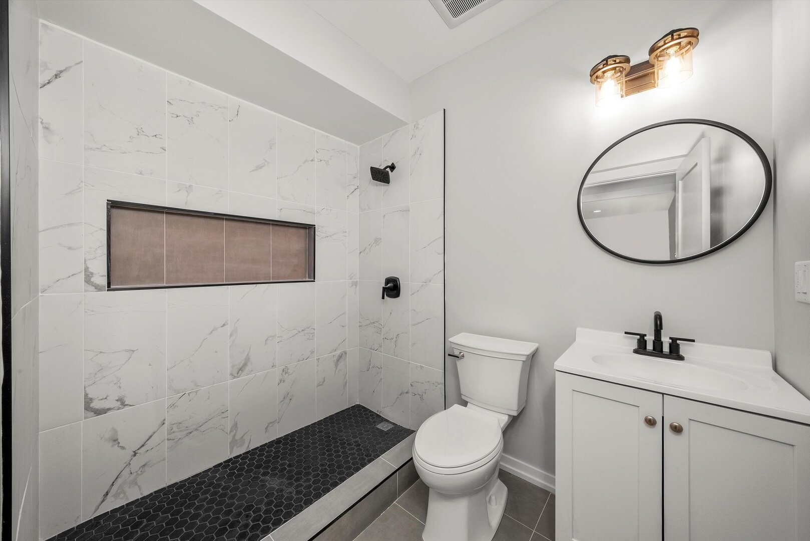 5738 South Archer Avenue Chicago, IL 60638 - Photo 11 of 16 a bathroom with a toilet sink and mirror