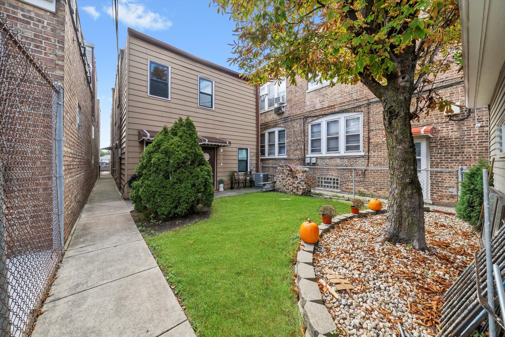 5738 South Archer Avenue Chicago, IL 60638 - Photo 16 of 16 a front view of a house with a garden