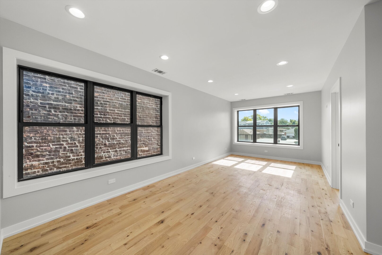 5738 South Archer Avenue Chicago, IL 60638 - Photo 3 of 16 a view of an empty room with a window and wooden floor