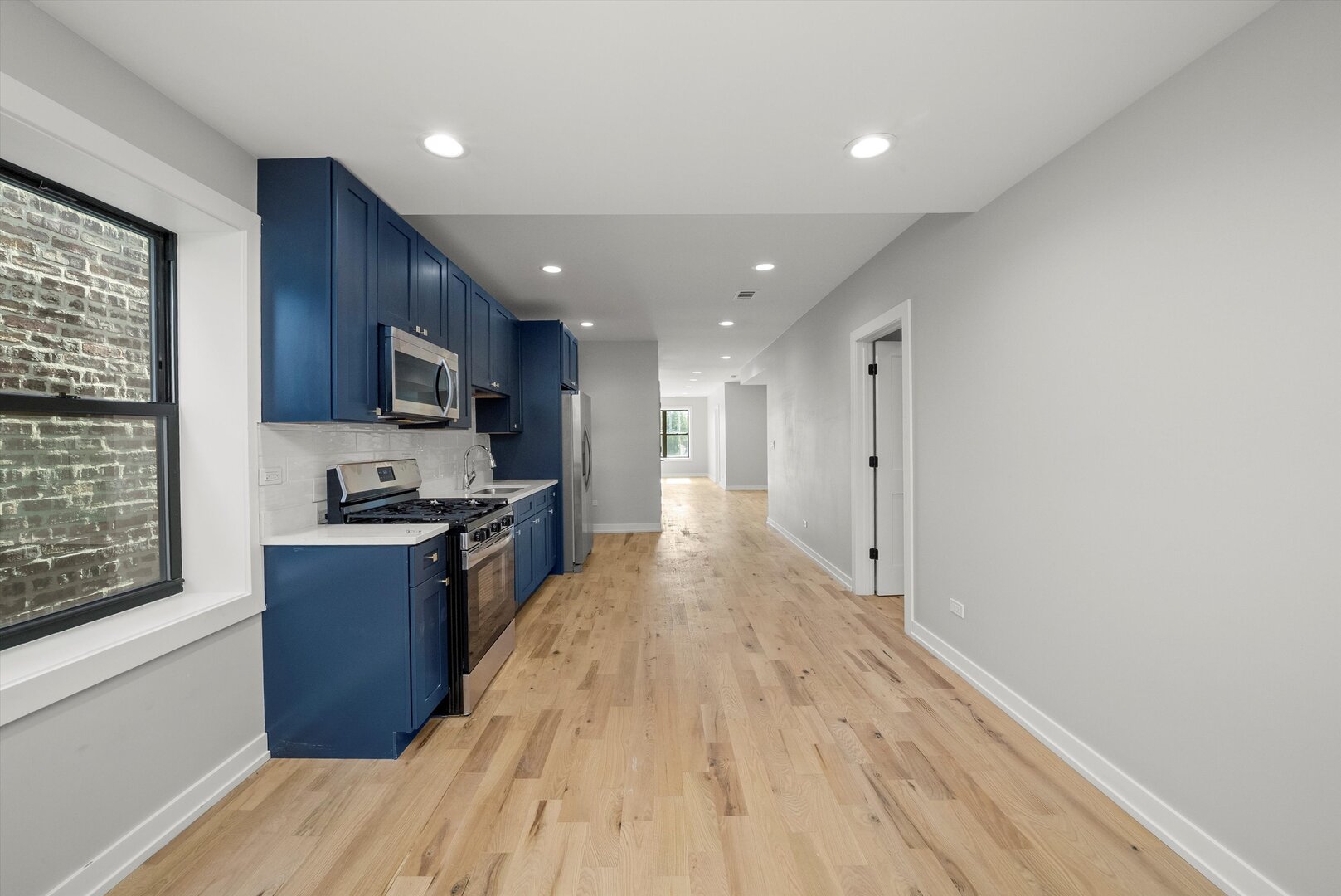 5738 South Archer Avenue Chicago, IL 60638 - Photo 10 of 16 a large kitchen with stainless steel appliances granite countertop a large counter top a sink and a refrigerator