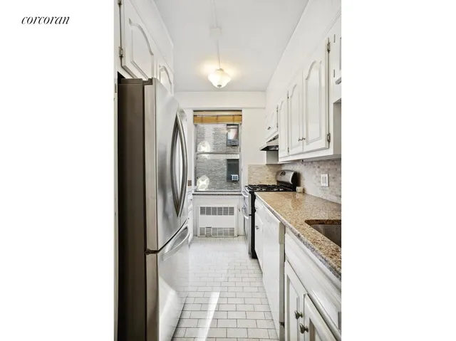 a kitchen with a sink cabinets and stainless steel appliances