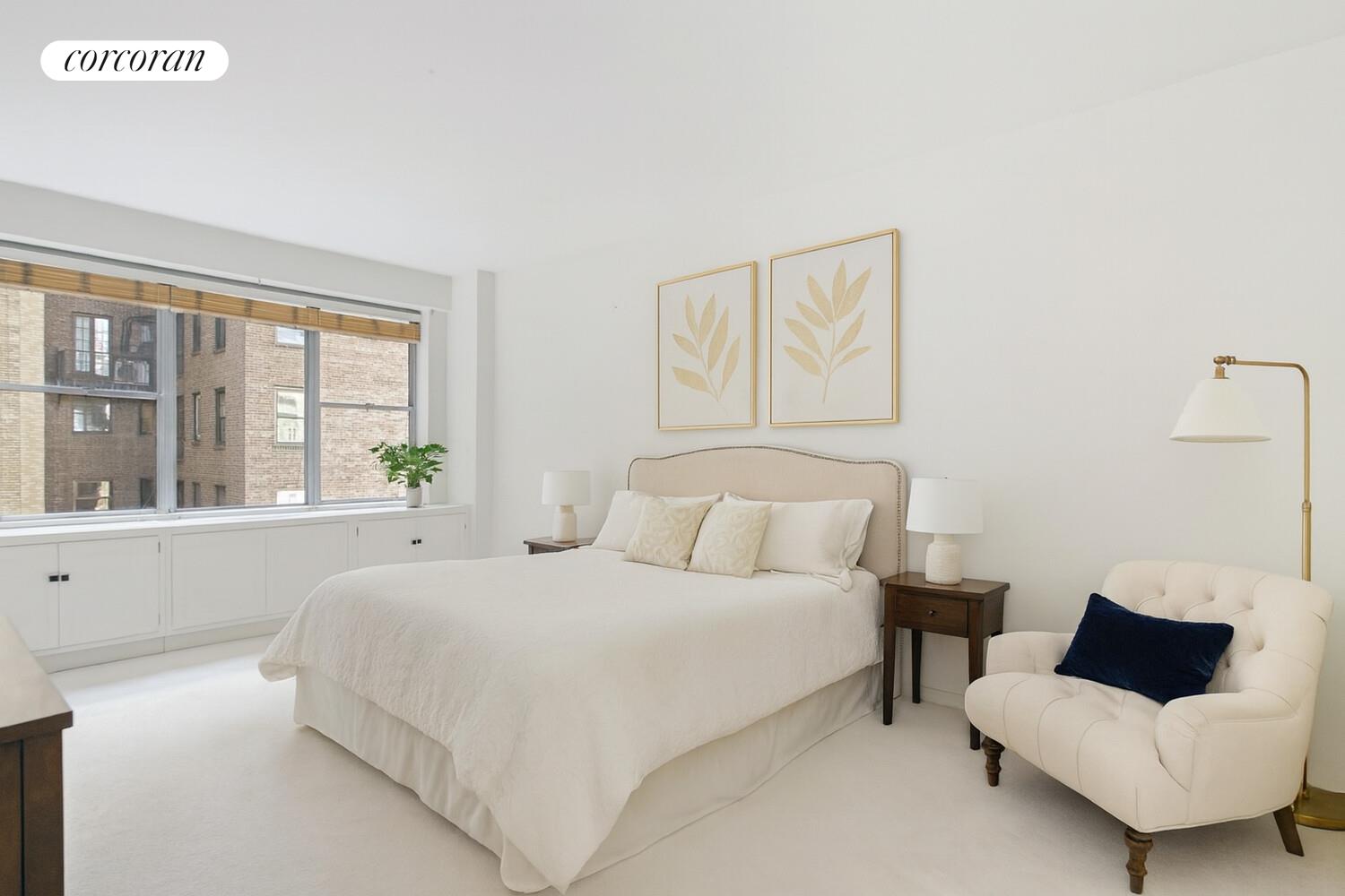 12 Beekman Place, Unit 8D Manhattan, NY 10022 - Photo 5 of 7 a bedroom with a bed and a couch