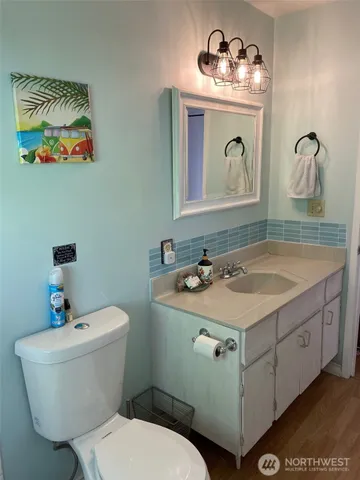 a bathroom with a toilet sink and mirror