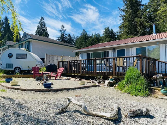 a view of a house with backyard porch and sitting area