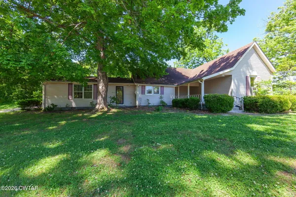 a view of house with backyard and a patio
