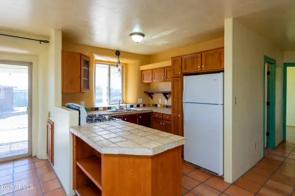 a view of kitchen with sink and cabinets