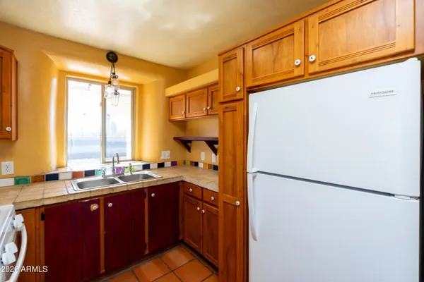 a kitchen with a sink appliances and cabinets