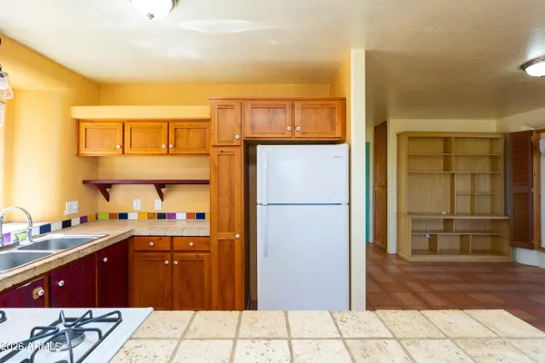 an entryway to room with wooden floor and windows