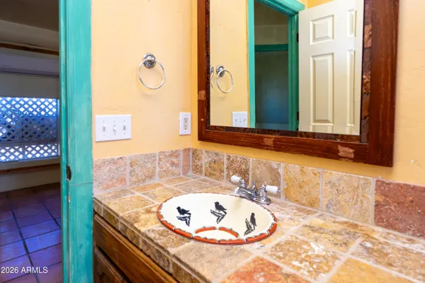 an empty room with a ceiling fan and carpet